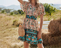 Women's boho V-neck A-line dress with short sleeves, teal floral border, cinched waist