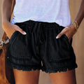 Black denim shorts with elastic waist, drawstring, and frayed fringe hem