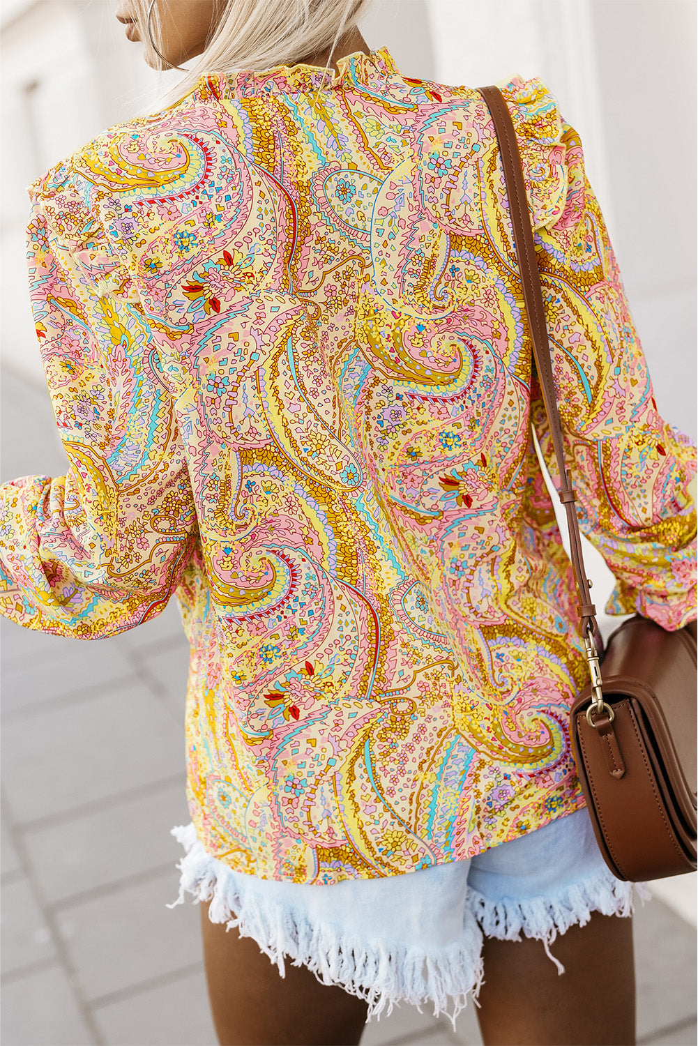 Yellow paisley shirt with ruffled neckline and long sleeves, back view