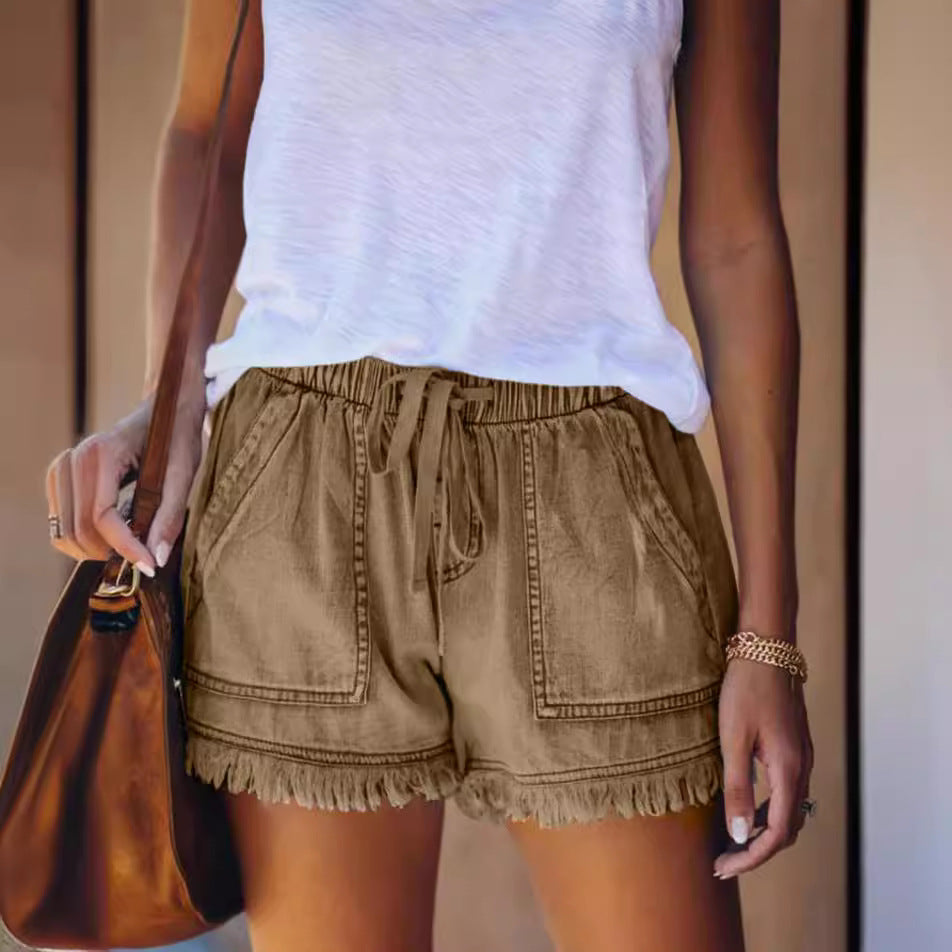 Khaki denim shorts with elastic waist, drawstring, and frayed fringe hem