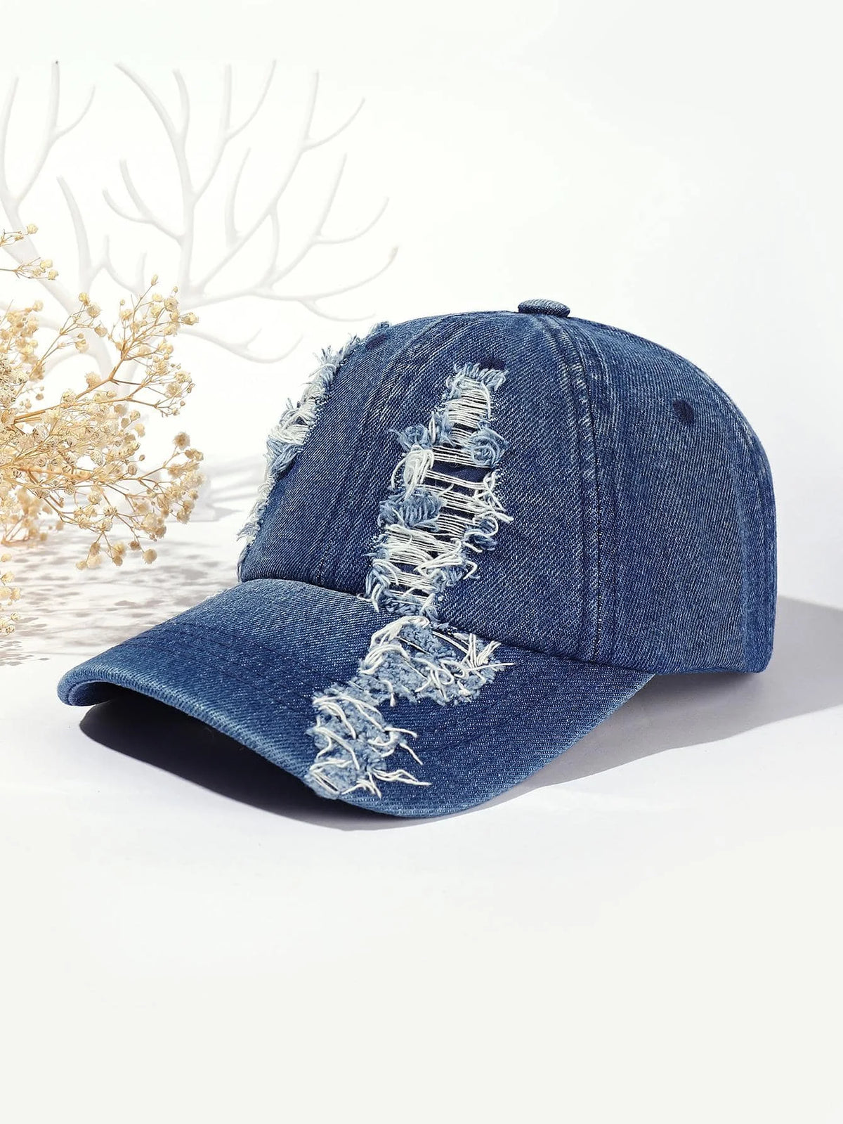 Deep blue washed distressed baseball cap with white ripped graphic