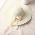 Ivory wide-brim straw sun hat with long ribbon bow