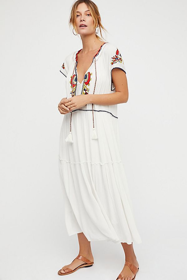 White tiered maxi dress with colorful V-neck embroidery and short sleeves