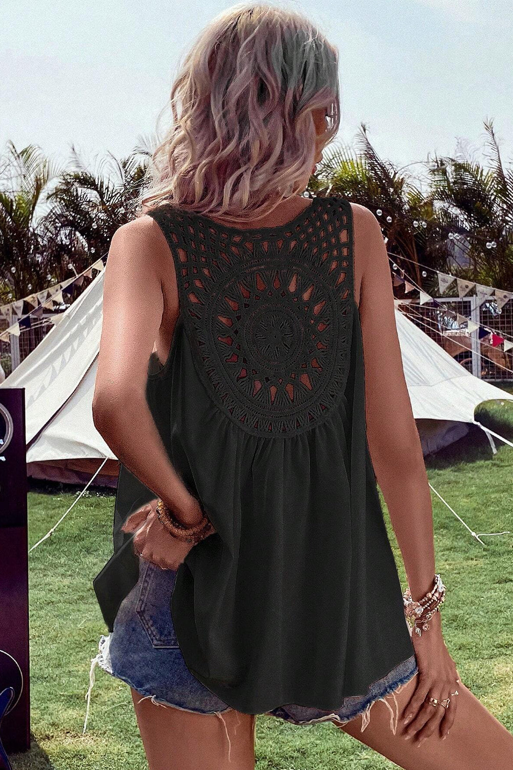 Black sleeveless tunic back view with circular crochet yoke and flowing gathered skirt