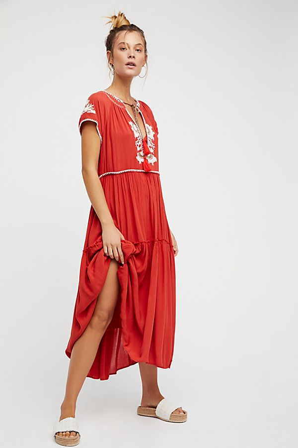 Red tiered maxi dress with white embroidery and front draped slit