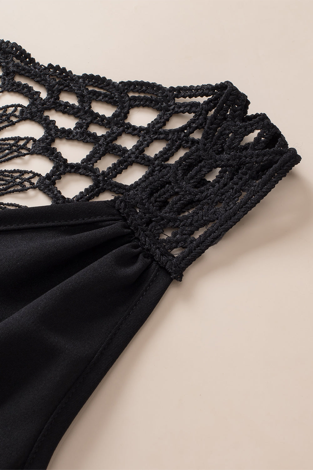 Black sleeveless tunic neckline and crochet lattice trim with gathered waist detail