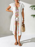 White womens beach cover-up with V neckline and colorful embroidered trim, mid-calf length