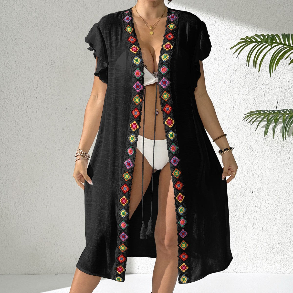 Black womens beach cover-up with open V neckline and colorful embroidered trim, midi length