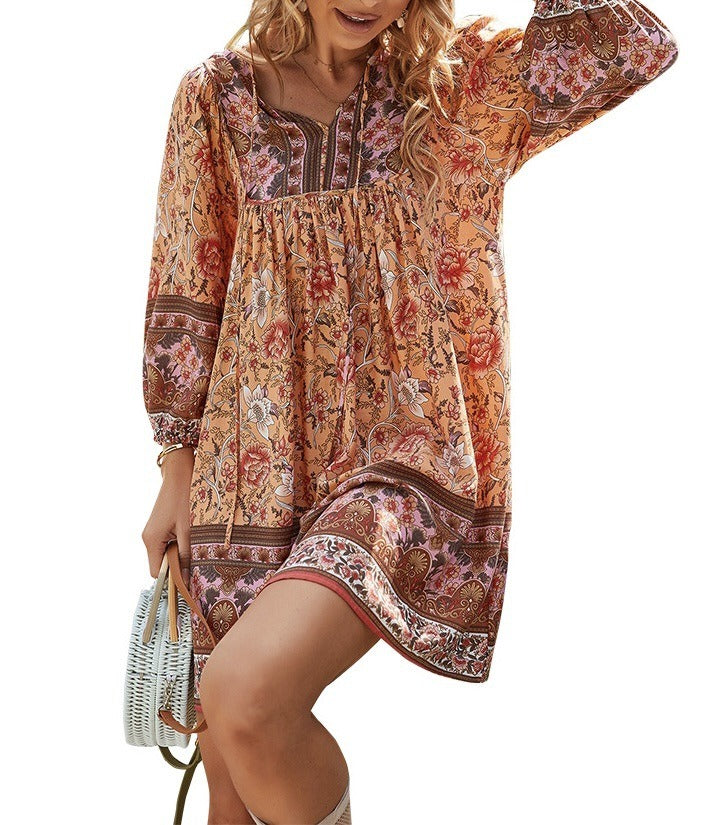 Bohemian printed long-sleeve A-line dress with V-neck lace-up detail, warm orange pattern