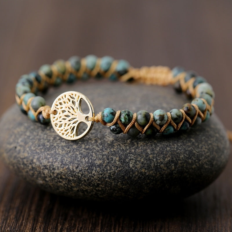 Green stone beaded wrap bracelet with tree of life charm and braided leather cord.