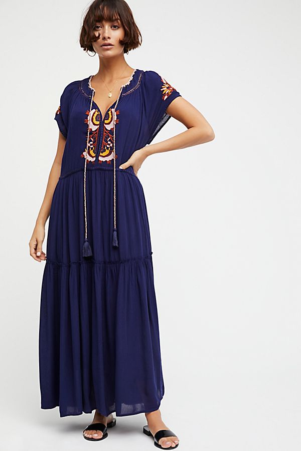 Navy blue tiered maxi dress with decorative embroidery at neckline