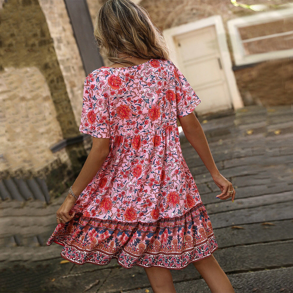 Red floral bohemian dress, back view, with short sleeves and tiered ruffle skirt