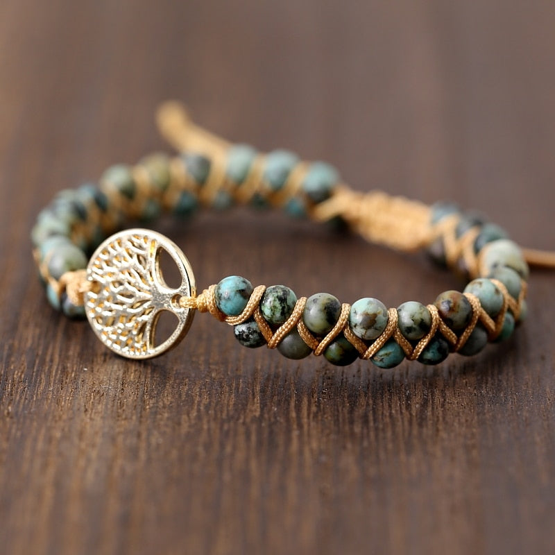Green stone beaded wrap bracelet with gold tree of life charm and braided leather cord.