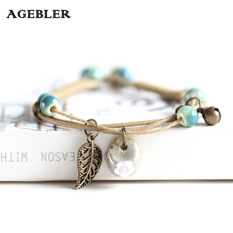 Boho ceramic flower leaf bracelet with teal beads and antique bronze leaf charm