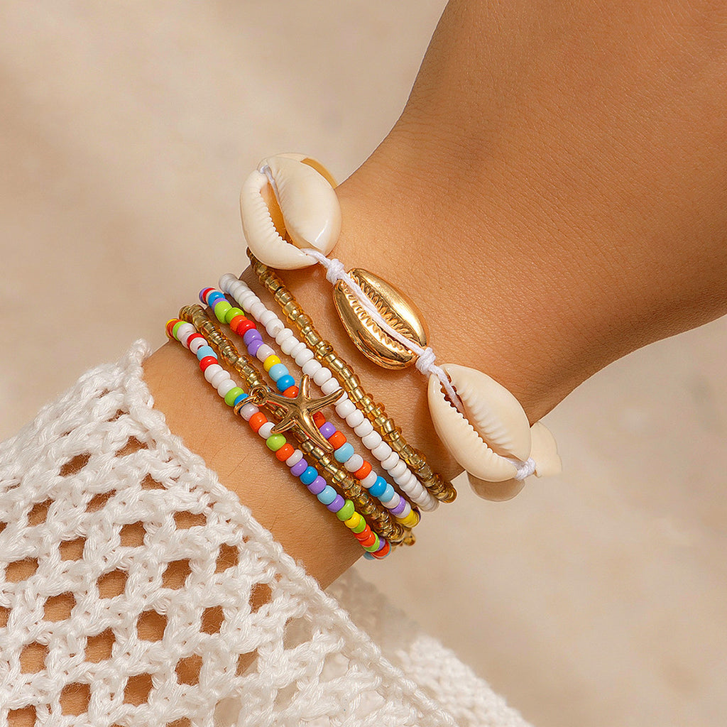 Star Island shell bracelet with multicolor beads and cowrie shell charms, on wrist