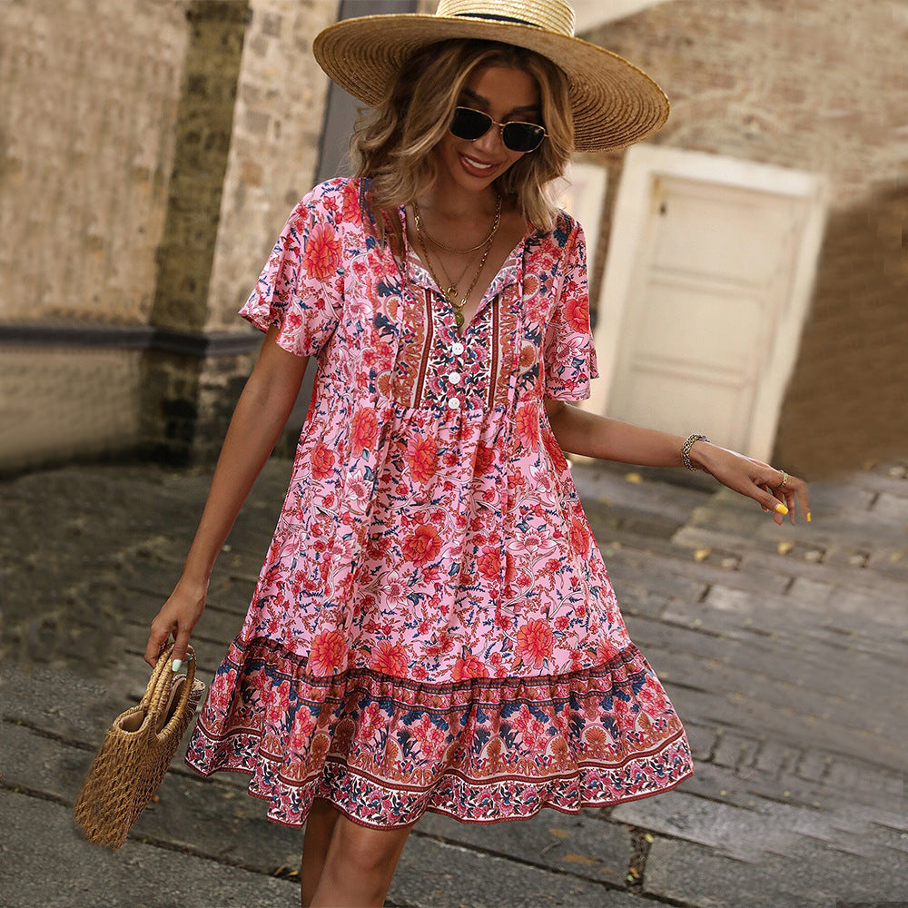 Red floral V-neck boho dress with short sleeves and navy-trimmed tiered hem