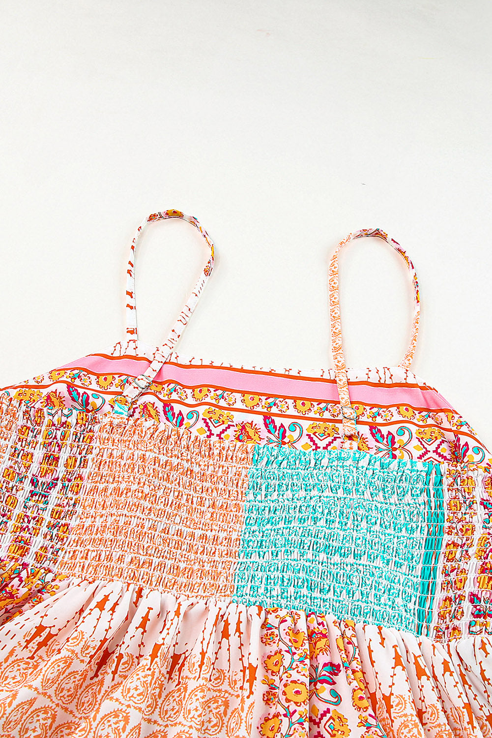 Patchwork sundress close-up: gathered multicolor bodice and turquoise accent panel