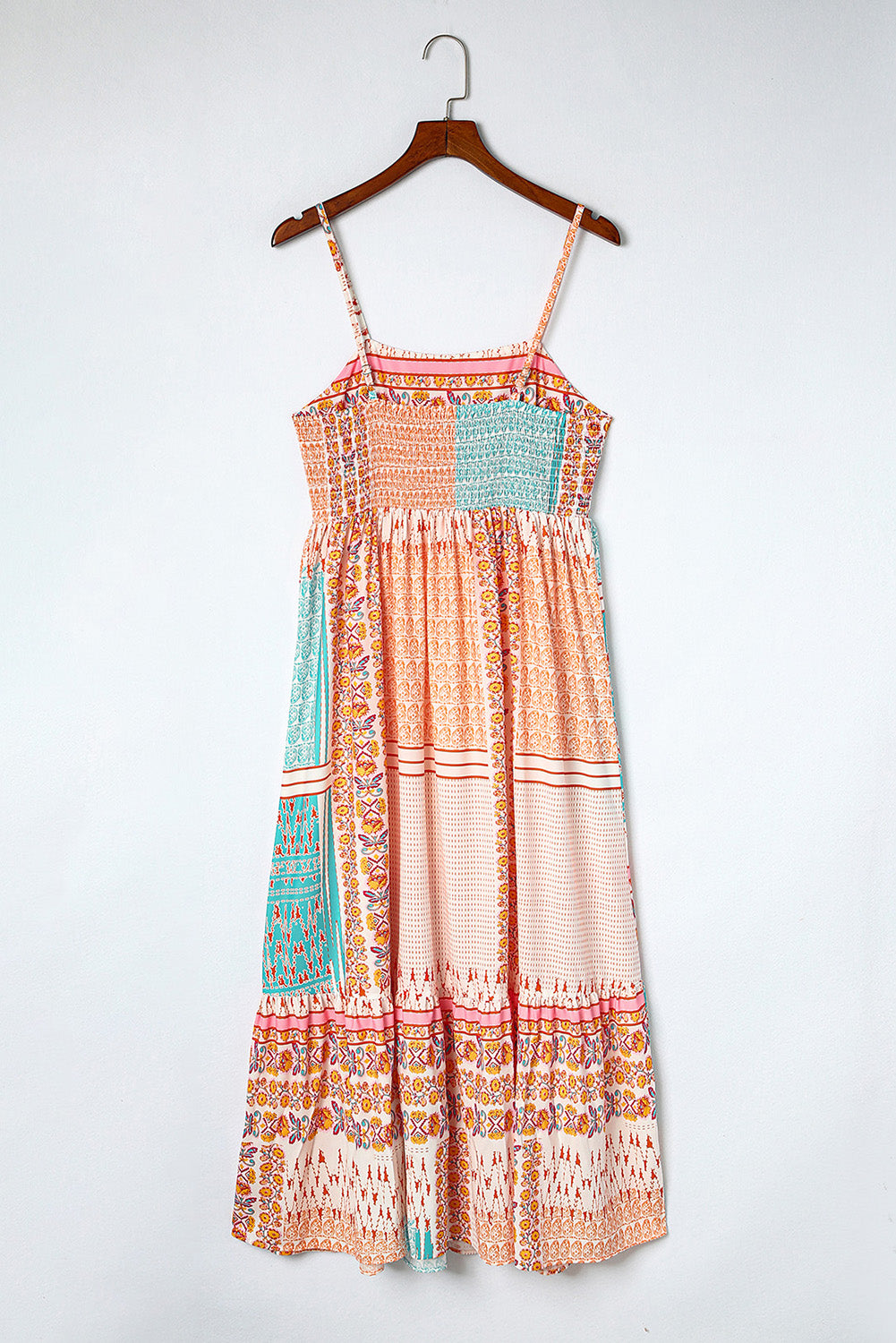 Patchwork square-neck sundress on hanger, peach orange and turquoise tiered pattern